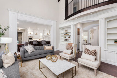 Beautiful living room interior with hardwood floors, view of kitchen and dining room in new luxury home